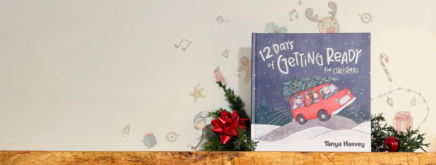 Book titled '12 Days of Getting Ready for Christmas' by Tanya Harvey on a wooden surface with festive decorations.